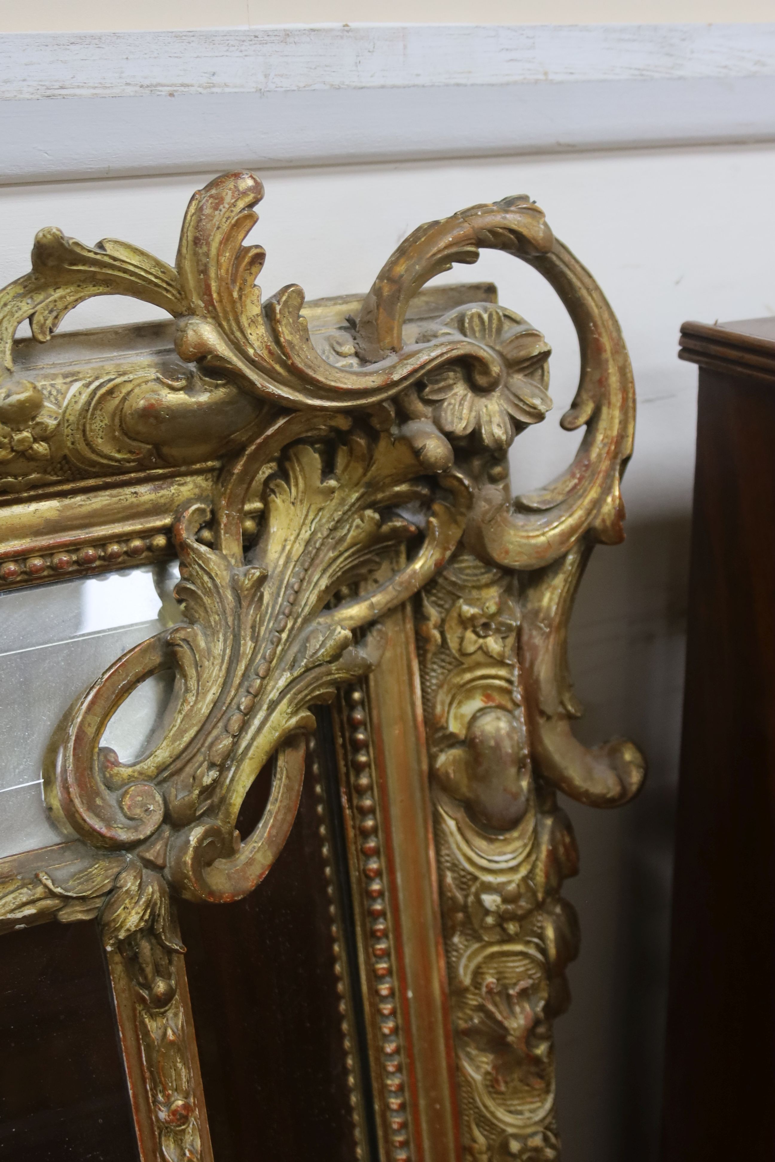 A large 19th century French gilt and gesso frame, bevel edged mirror with cushion margin, plated and C scroll, width 108cm, height 137cm